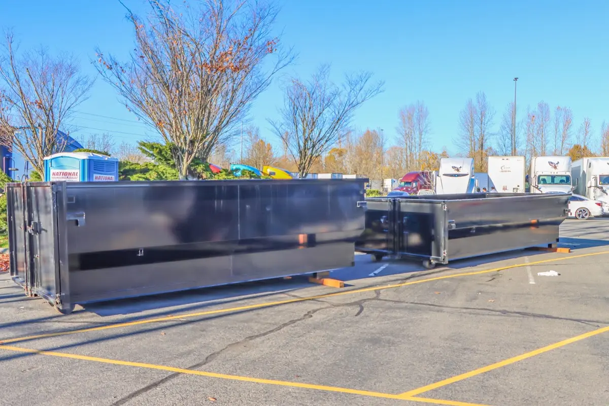 Professional dumpster rental service with roll-off container on residential driveway in Bellmawr